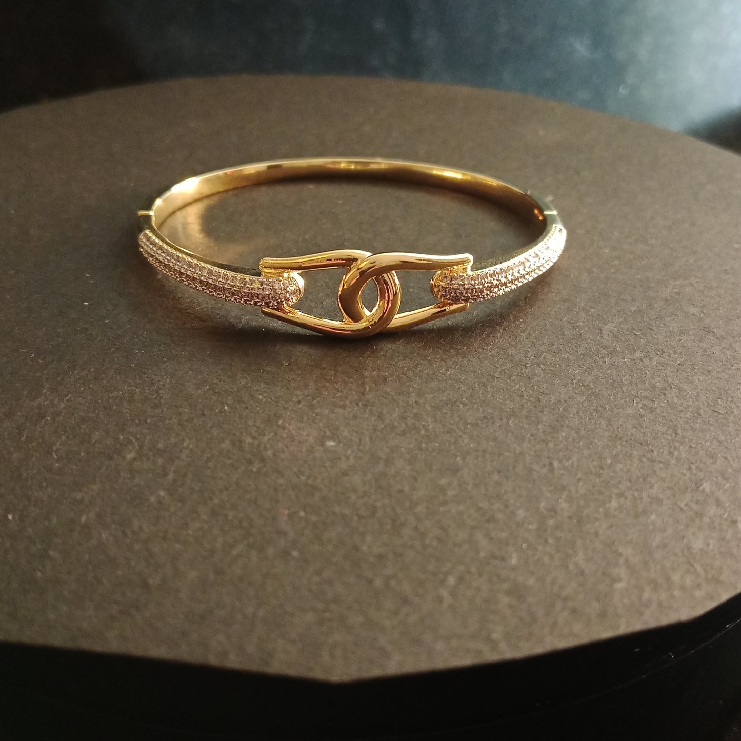 Elegant AD Bracelet with gold-plated safety link on brown surface – Blingso
