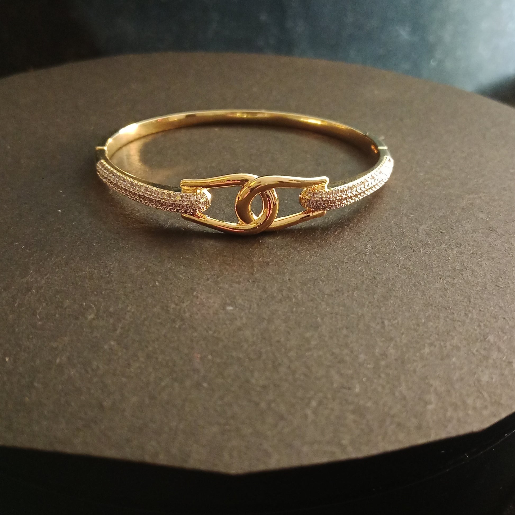 Elegant AD Bracelet with gold-plated safety link on brown surface – Blingso
