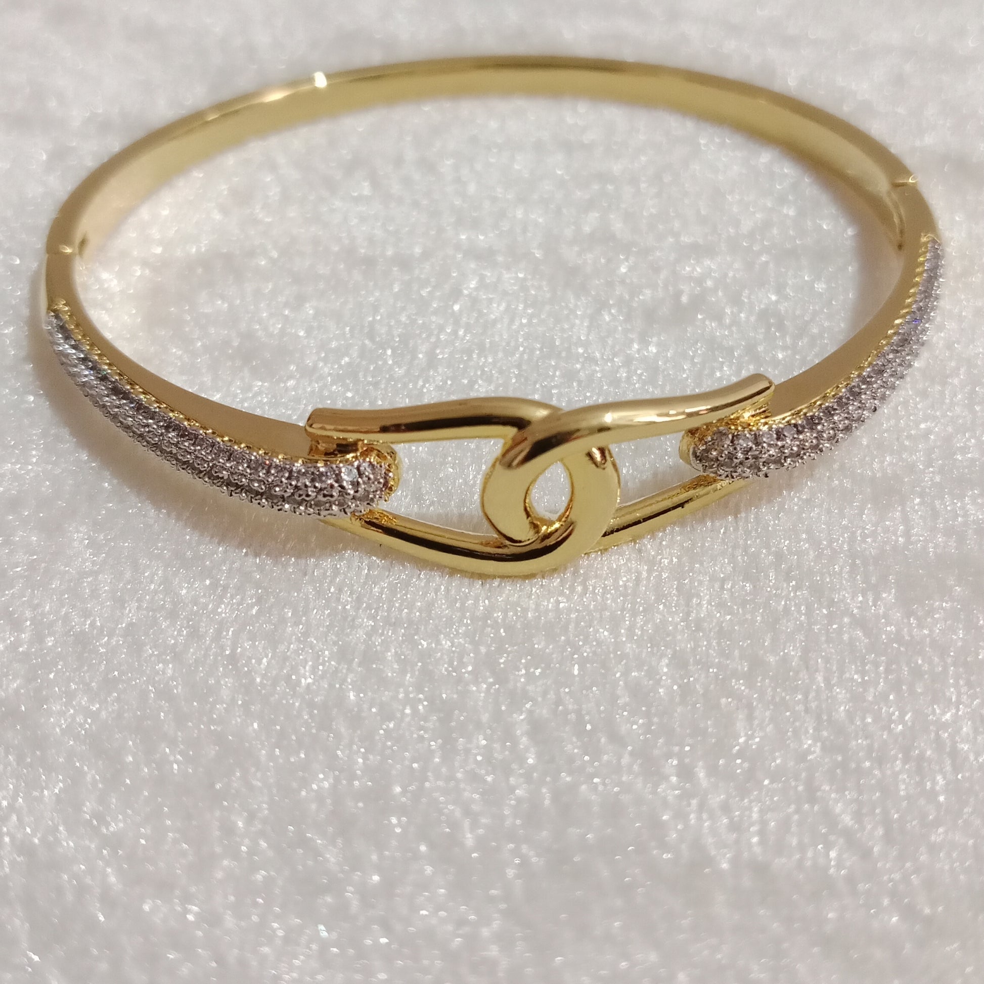 American Diamond Bracelet knot design close-up with gold polish – Blingso