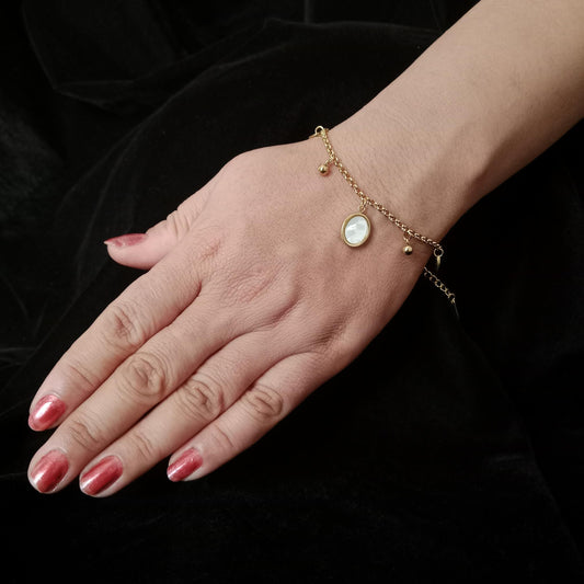 White Oval Charm Golden Chain Bracelet – angled view